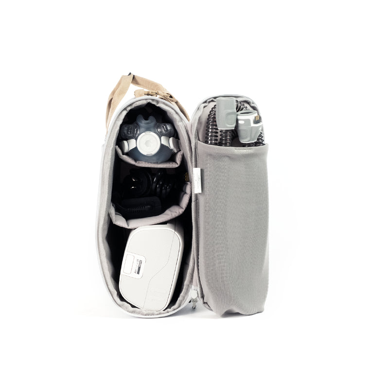 CPAP insert bag shown open, with a cpap machine and cpap mask accessories, on clean white background.