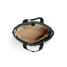Luxe Tote bag overhead view of a dark green canvas tote bag showing its beige interior lining and black handles, set against a plain white background.