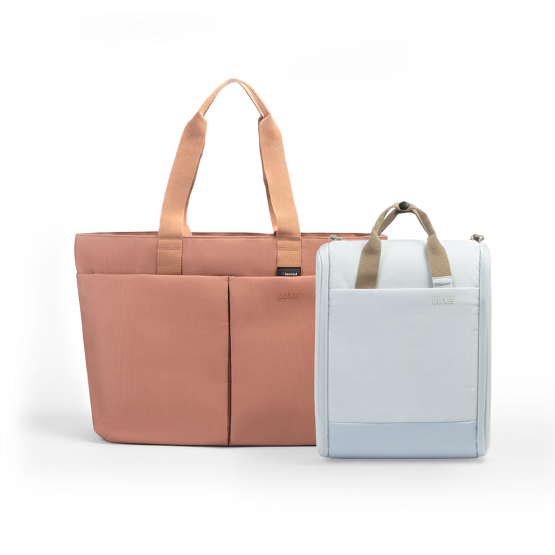 A pink tote luxe bag and a white cpap insert bag next to each other. The larger bag is dark green with black handles and front seam detailing.